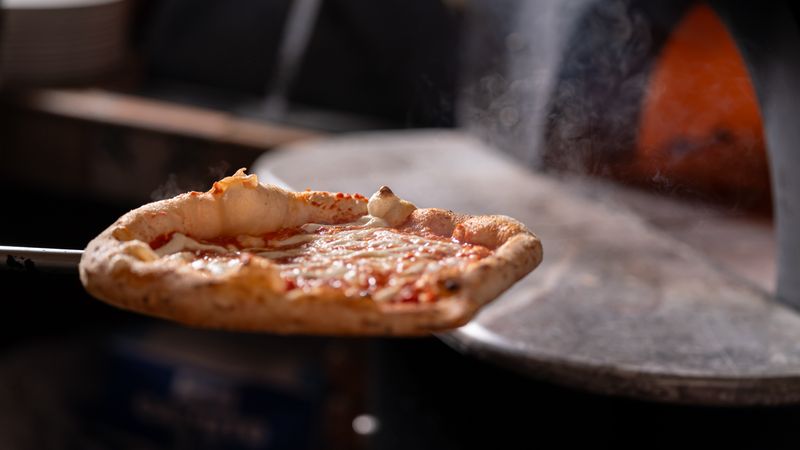 Pizza baking in the oven at dewey's pizza kitchen
